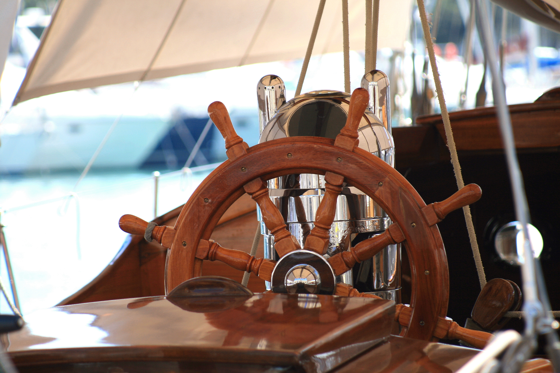 Polished timber ship's wheel on a classic yacht